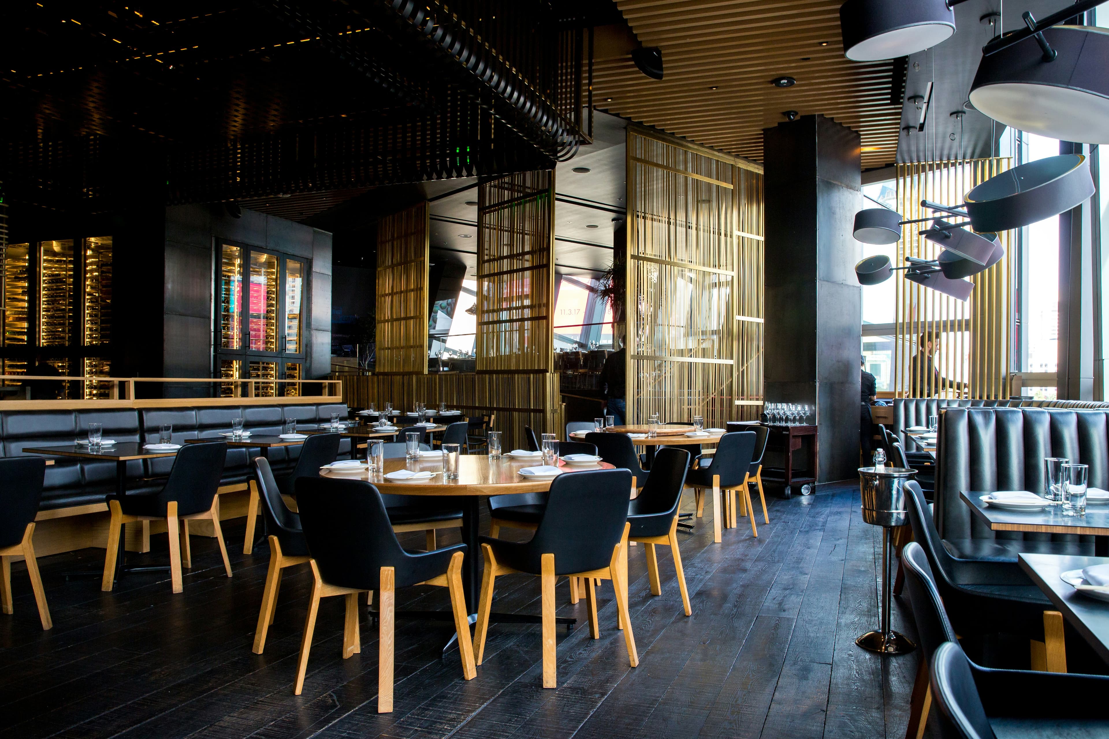 Moody upscale restaurant interior with gold accents and warm lighting